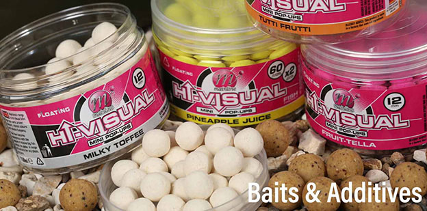 A display of various fishing baits and additives arranged neatly on a table